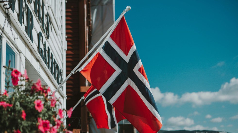 A Norwegian flag hung on the side of a building